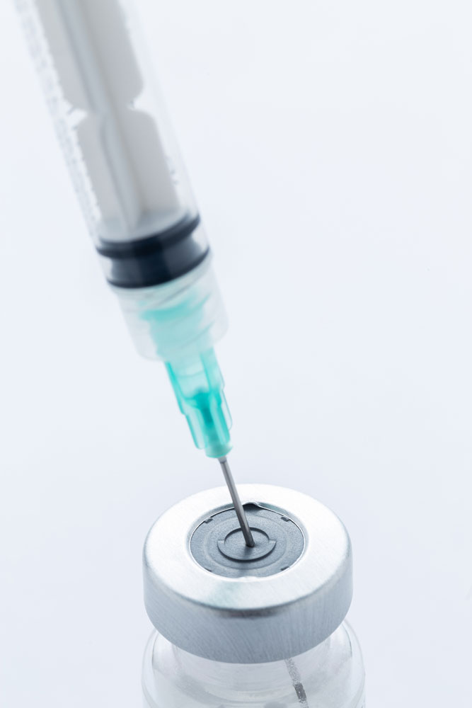 A,hypodermic,needle,inside,of,a,vial,containing,a,vaccine